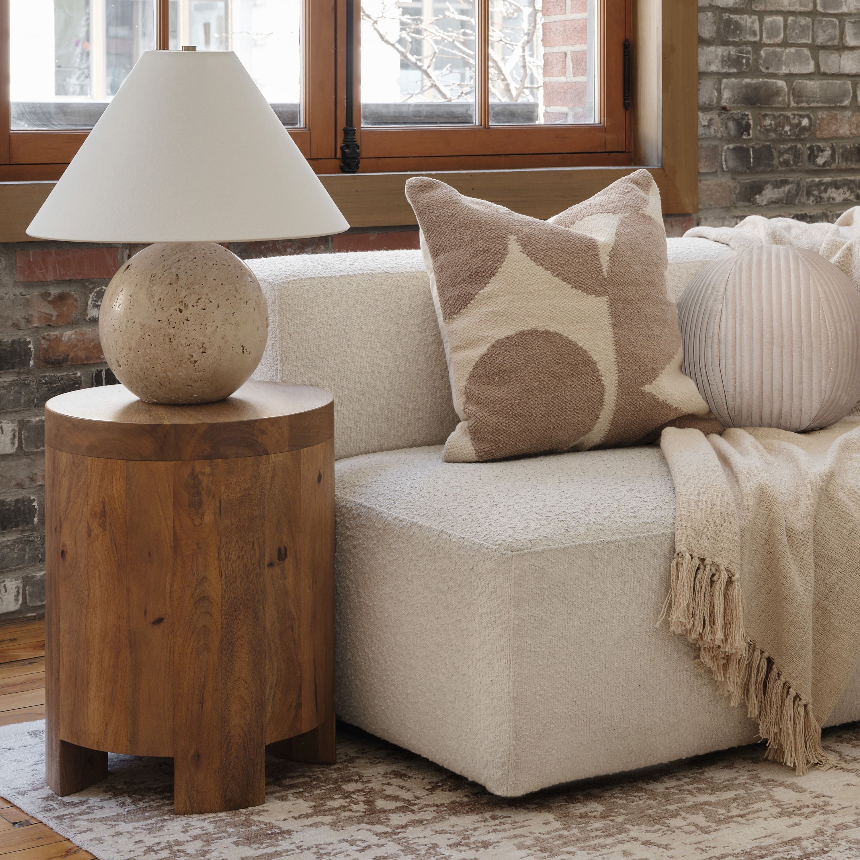 Assen table lamp by Renwil, travertine base, ivory linen shade, honed natural stone