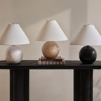 Assen table lamp by Renwil, travertine base, ivory linen shade, honed natural stone