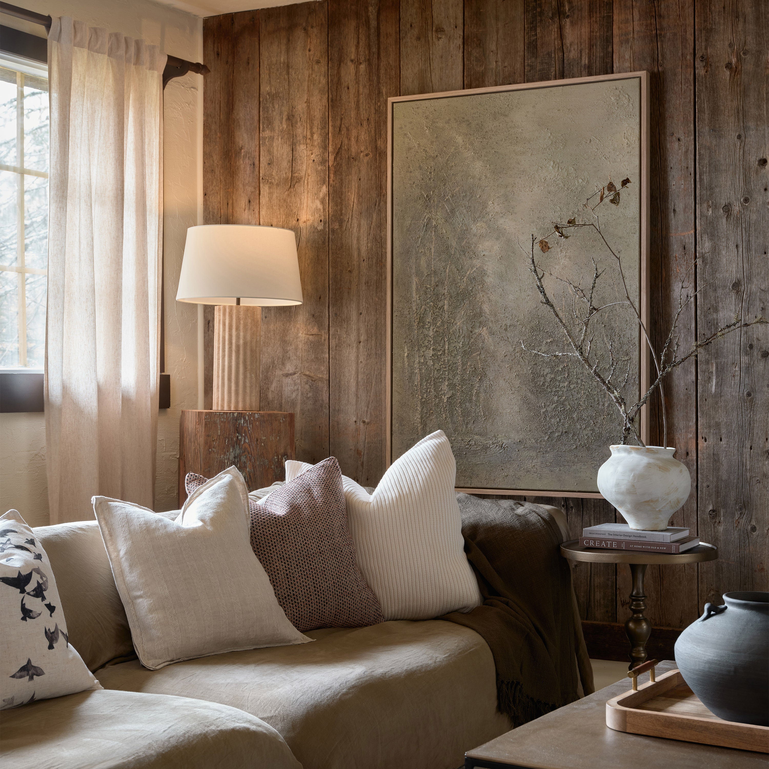 Milena table lamp by Renwil, travertine column base, ivory linen shade, fluted stone